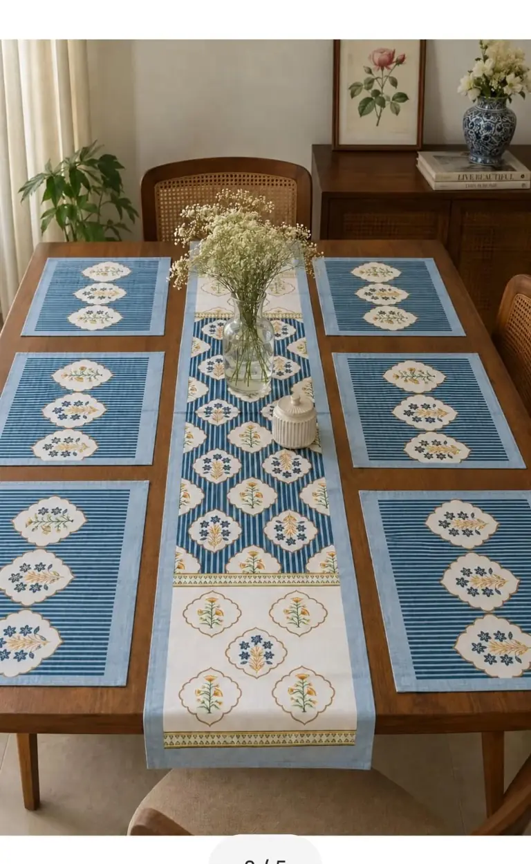 Blue and cream table linen arranged on a dining table
