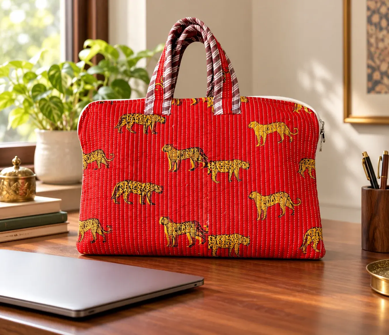 Handblock printed laptop bag styled on a wooden desk